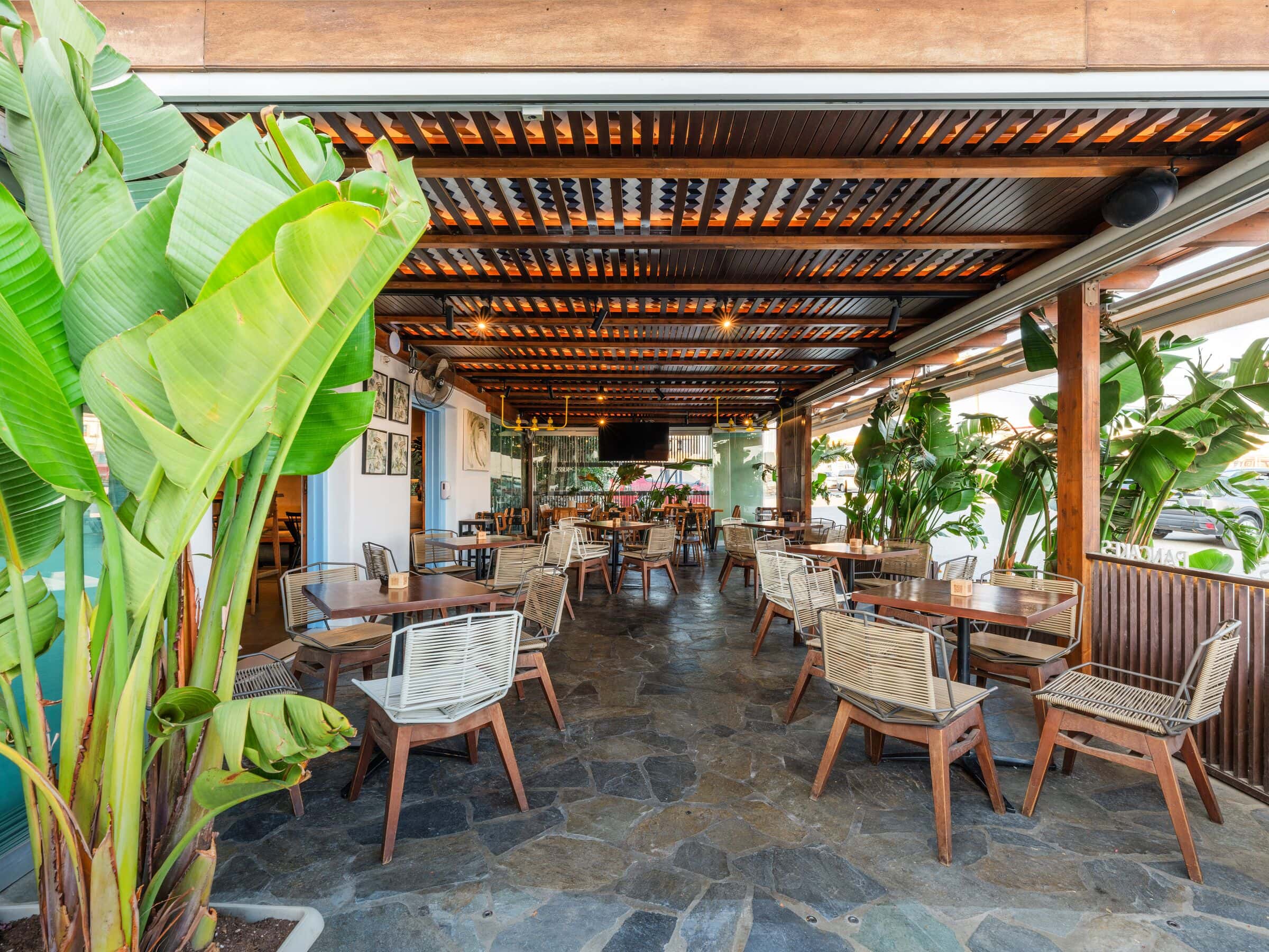 The covered courtyard seen through banana plants